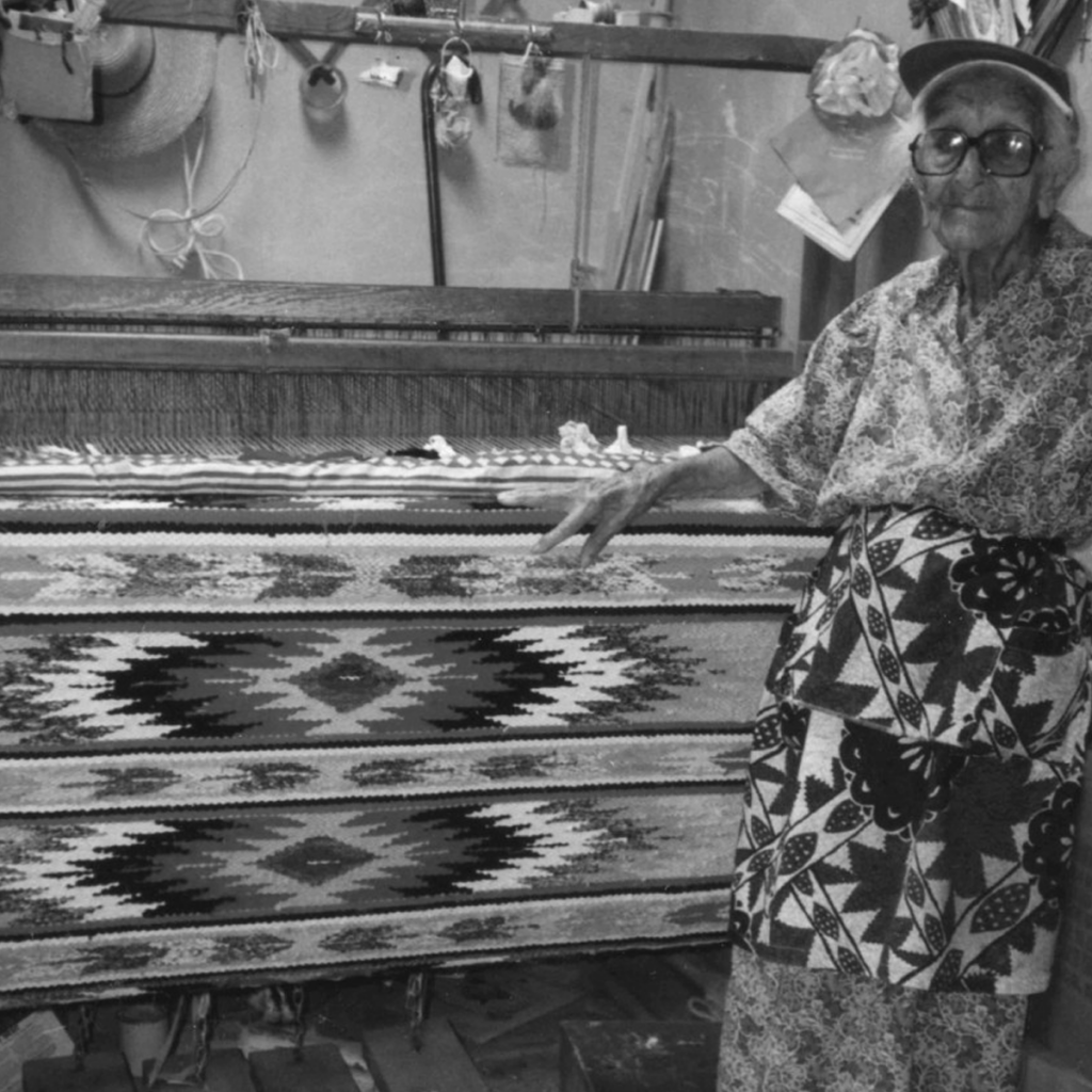 Agueda S. Martinez with her tapestries.