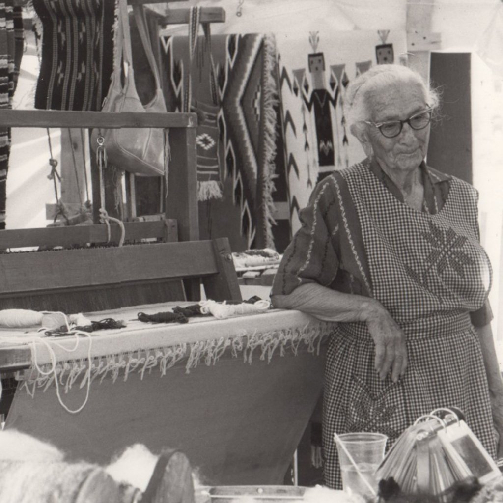 Agueda S. Martinez with her loom and tapestries.